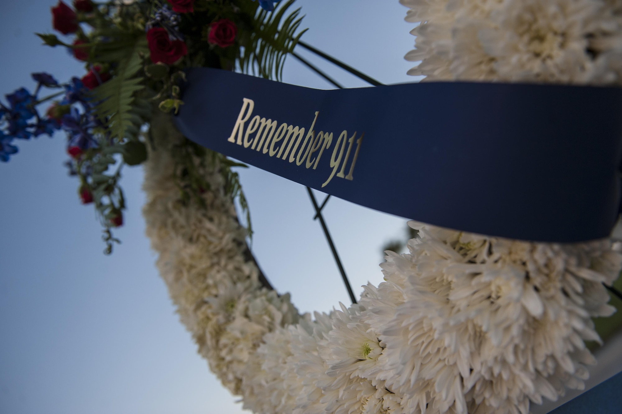 A wreath made to honor the victims of Sept. 11 hangs in front of the base flag pole, Sept. 9, 2016. To honor those Americans’ sacrifices, Airmen from Nellis Air Force Base stood post from 6:30 a.m. to 4:30 p.m. in thirty minute shifts. (U.S. Air Force photo by Airman 1st Class Kevin Tanenbaum/Released)