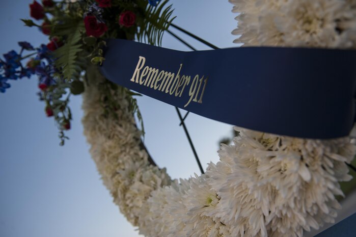 A wreath made to honor the victims of Sept. 11 hangs in front of the base flag pole, Sept. 9, 2016. To honor those Americans’ sacrifices, Airmen from Nellis Air Force Base stood post from 6:30 a.m. to 4:30 p.m. in thirty minute shifts. (U.S. Air Force photo by Airman 1st Class Kevin Tanenbaum/Released)