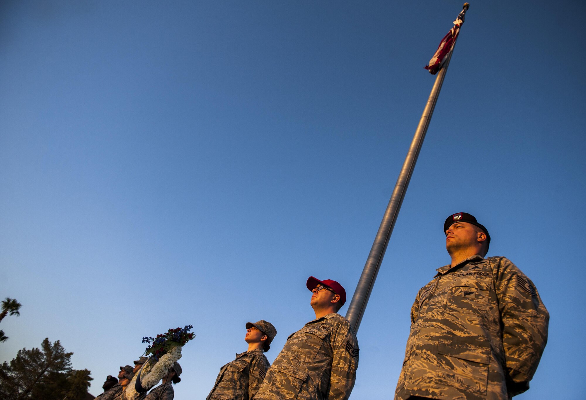 Airmen from Nellis Air Force Base stand at post to honor the lives lost on Sept. 11 in front of the base flagpole, Sept. 9, 2016. On 9/11, the United States experienced the largest attack on domestic soil since Pearl Harbor, causing the deaths of thousands of civilians and first responders. (U.S. Air Force photo by Airman 1st Class Kevin Tanenbaum/Released)