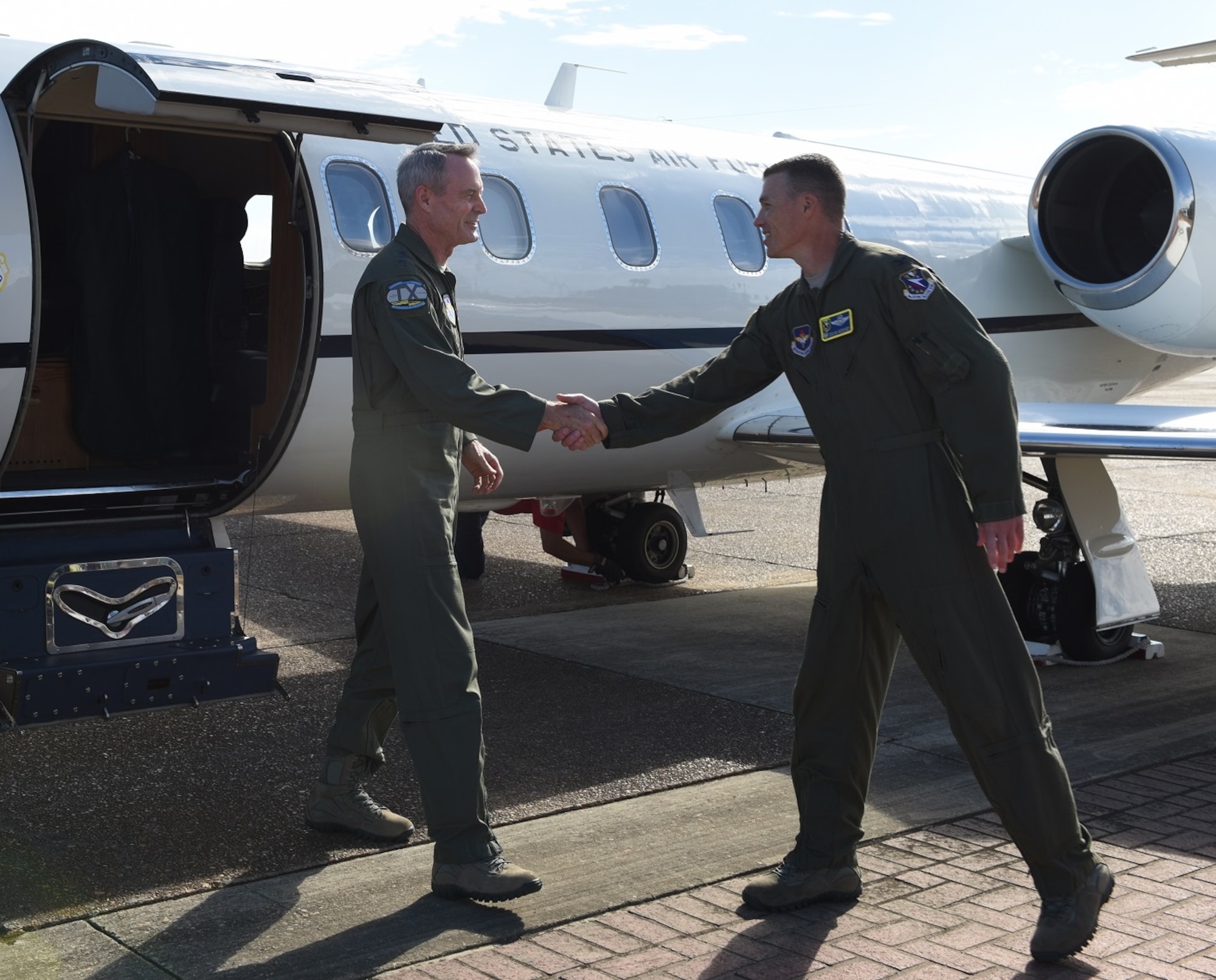 Lt. Gen. Darryl Roberson, commander of Air Education and Training Command, is greeted by Col. Douglas Gosney, 14th Flying Training Wing Commander, as he steps onto the flightline Sept. 12, 2016 at Columbus Air Force Base, Mississippi. Roberson accompanied by his wife Cheryl and Chief Master Sgt. David Staton, AETC Command Chief, visited Columbus to meet Team BLAZE. (U.S. Air Force photo/Elizabeth Owens)