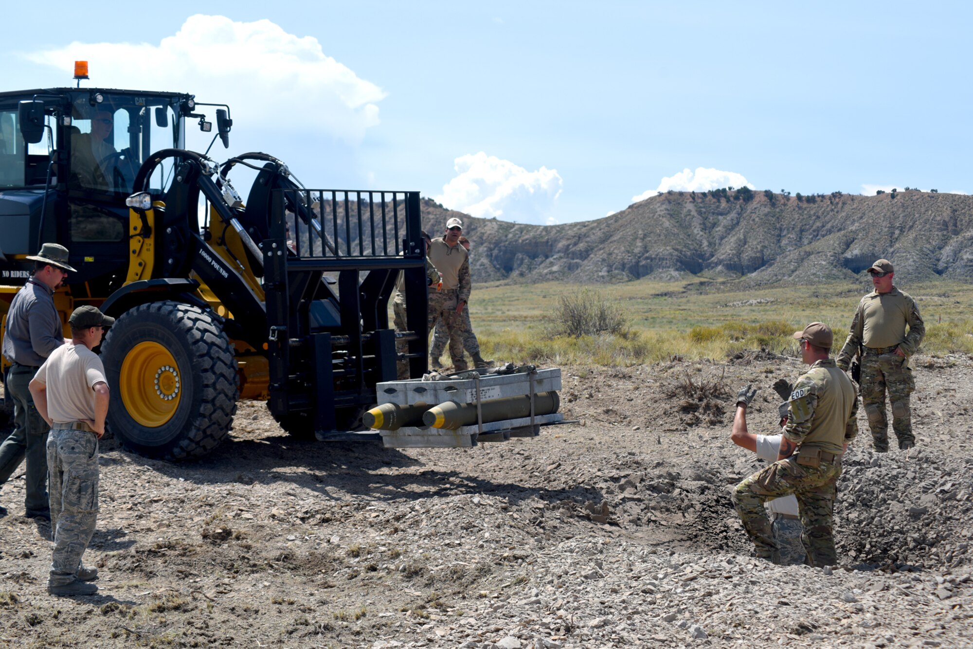 FORT CARSON, Colo. – Explosive Ordnance Disposal technicians from around the Colorado Springs community lower explosives in preparation for at a live, mass-demolition training operation at a bombing range on Fort Carson, Colo., Aug 31, 2016. The team set out to test their skills during training coordinated by the 21st Civil Engineer Squadron EOD flight. (U.S. Air Force photo by Airman 1st Class Dennis Hoffman)