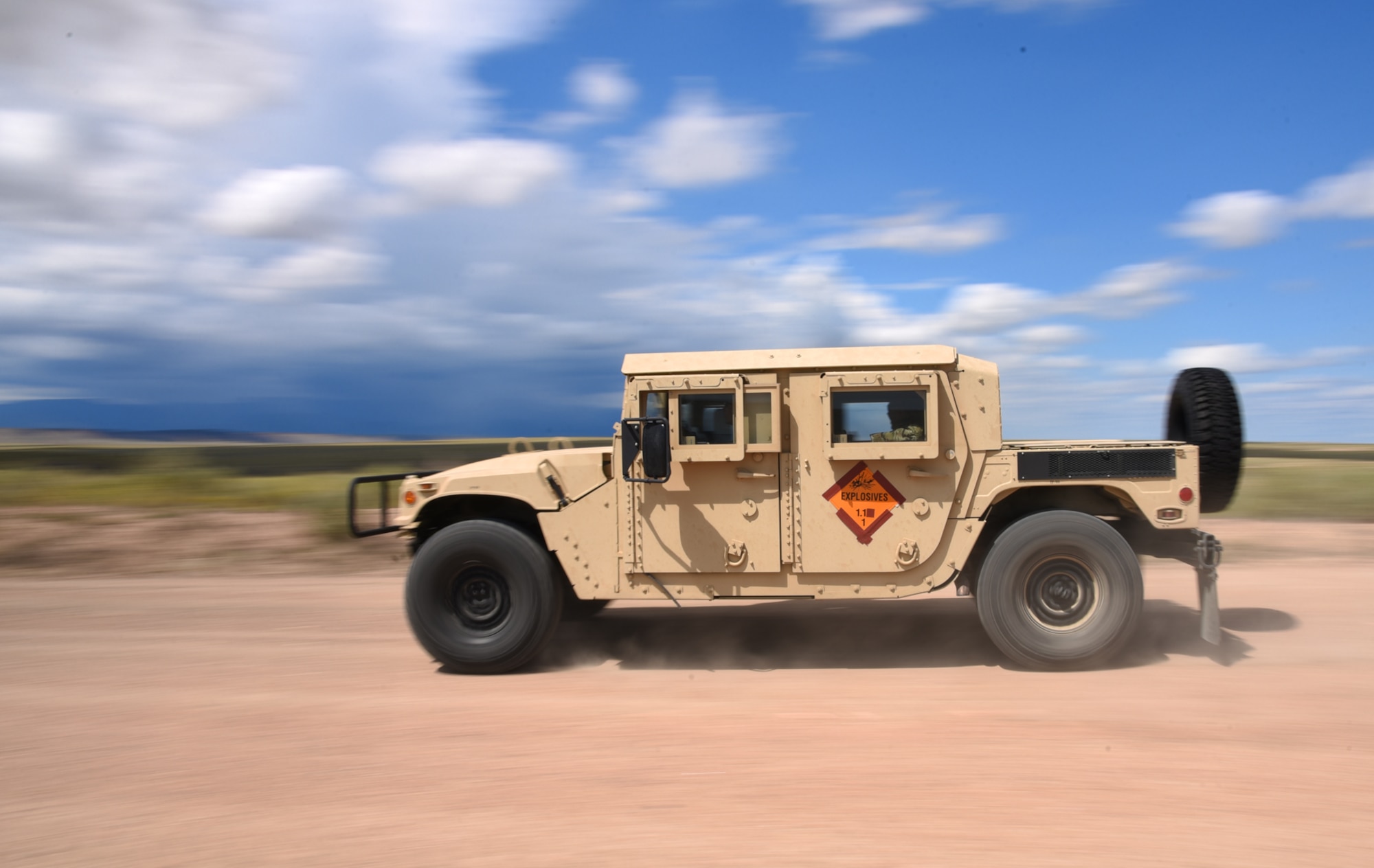 FORT CARSON, Colo. – Explosive Ordnance Disposal technicians from the Colorado Springs military community speed away from the blast site in a Humvee at the bombing range on Fort Carson, Colo., Aug 31, 2016. From the time the blast caps were set, the EOD team had 15 minutes to proceed to the viewing area and detonate the explosives. (U.S. Air Force photo by Airman 1st Class Dennis Hoffman)