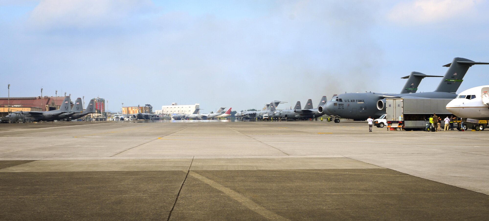 A variety of aircraft wait on the flight line at Yokota Air Base, Japan, Sep. 7, 2016. Due to the base’s strategic location, as well as refueling and maintenance capabilities, Yokota regularly supports aircraft from other U.S. bases. (U.S. Air Force Photo by Airman 1st Class Baker/Released)