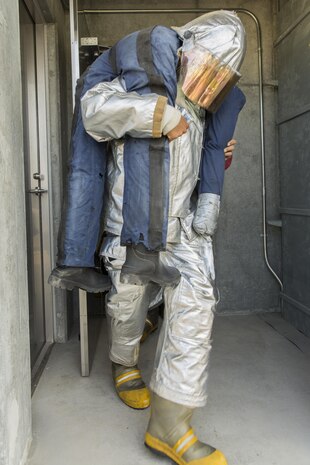 A U.S. Marine carries a simulated casualty during a 9/11 Memorial Stair Climb at Marine Corps Air Station Iwakuni, Japan, Sept. 9, 2016. Aircraft Rescue and Firefighting Marines with Headquarters and Headquarters Squadron hosted the event, which allowed station residents the opportunity to walk in the shoes of the firefighters who responded to the attacks. (U.S. Marine Corps photo by Lance Cpl. Aaron Henson)