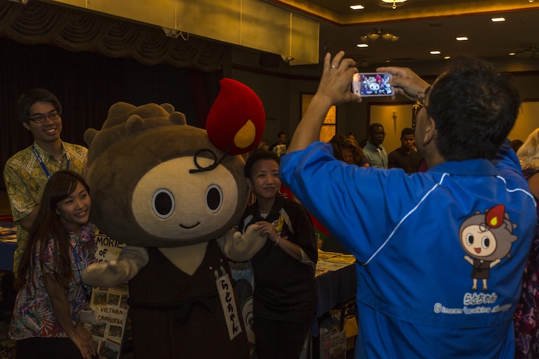 Japanese locals pose for a photo with Rato-chan, the official mascot of Ota City, during the Iwakuni Expo at Marine Corps Air Station Iwakuni, Japan, Sept. 10, 2016. The expo provided residents a glimpse of the services that are available to them on and off the air station such as tourist destinations, shopping malls and local hotels. (U.S. Marine Corps photo by Lance Cpl. Aaron Henson)