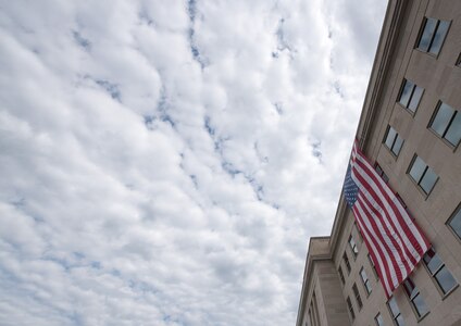 An American flag adorns the Pentagon during a 9/11 remembrance ceremony at the Pentagon Memorial, Sept. 11, 2016. President Barack Obama; Defense Secretary Ash Carter; and Marine Corps Gen. Joe  Dunford, chairman of the Joint Chiefs of Staff, delivered remarks during the event. DoD photo by Navy Petty Officer 2nd Class Dominique A. Pineiro