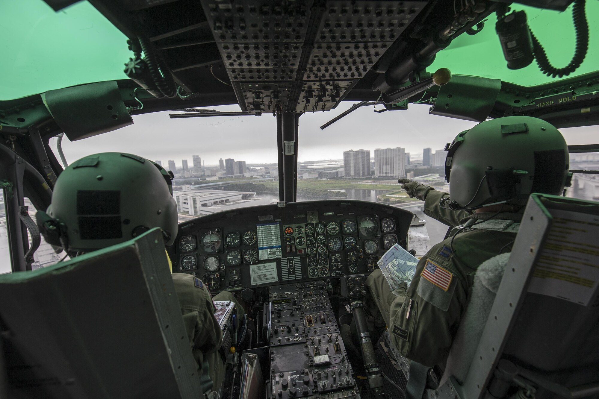 Capt. Jonathan Bonilla and Capt. Vicente Vasquez, 459th Airlift Squadron UH-1N Iroquois pilots, fly over Tokyo metropolis, Sept. 4, 2016. Airmen with the 459 AS delivered simulated disaster relief supplies to the Tokyo Rinkai Disaster Prevention Park during the Annual Tokyo Metropolitan Government Disaster Management Drill. The park is located in the Ariake area and is a disaster countermeasure headquarters of the Government of Japan and other local governments during large-scale earthquakes in the metropolitan area. (U.S. Air Force photo by Yasuo Osakabe/Released) 