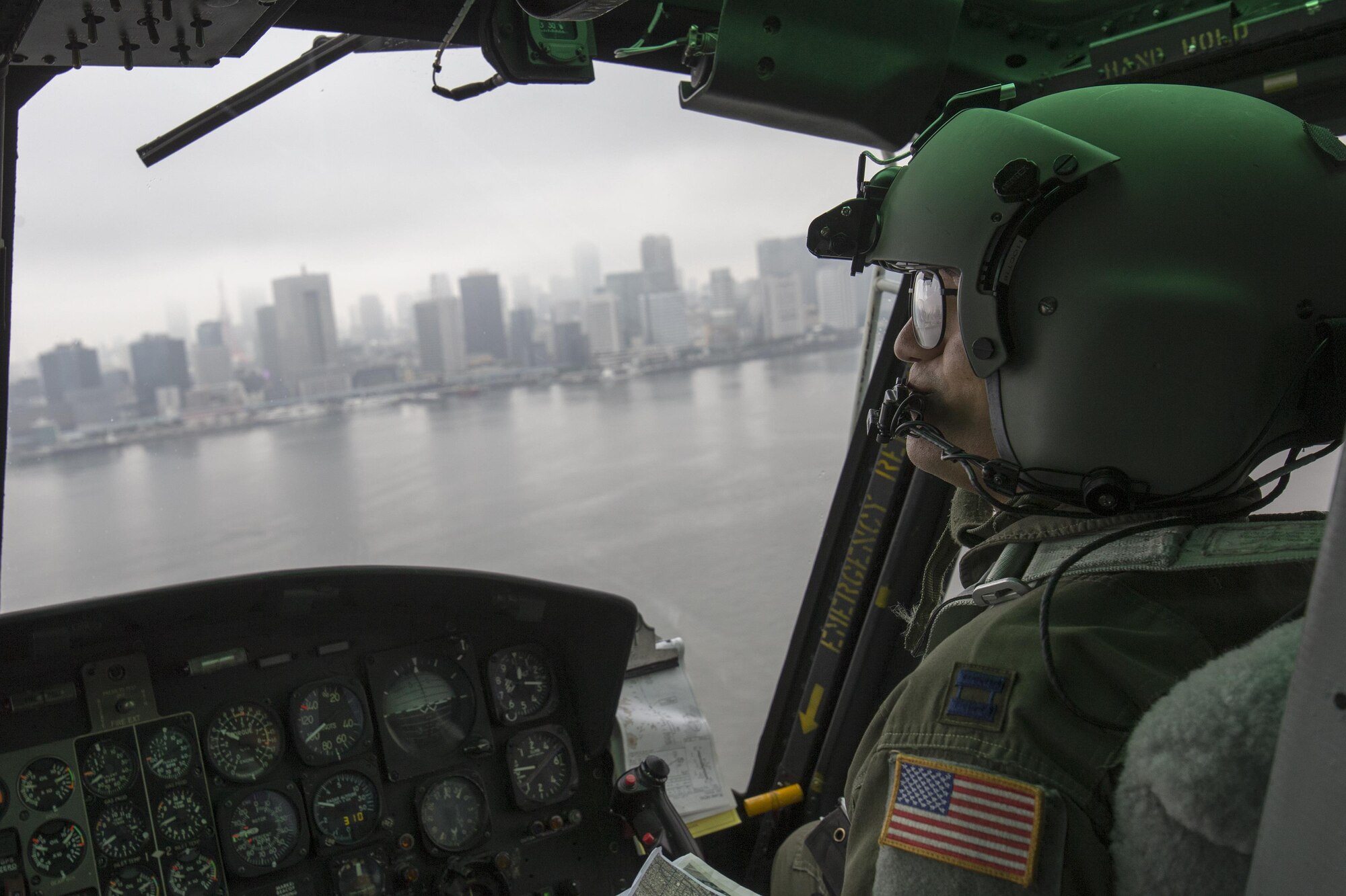 Capt. Vicente Vasquez, 459th Airlift Squadron UH-1N Iroquois pilot, flies over Tokyo Bay after delivering simulated relief supplies at Tokyo Rinkai Disaster Prevention Park, Japan, Sept. 4, 2016, during the Annual Tokyo Metropolitan Government Disaster Prevention Drill. Airmen with the 459 AS practiced delivering simulated relief supplies to Tokyo Rinkai Disaster Prevention Park in downtown Tokyo. The park is located in the Ariake area and is a disaster countermeasure headquarters of the Government of Japan and other local governments during large-scale earthquakes in the metropolitan area. (U.S. Air Force photo by Yasuo Osakabe/Released)    