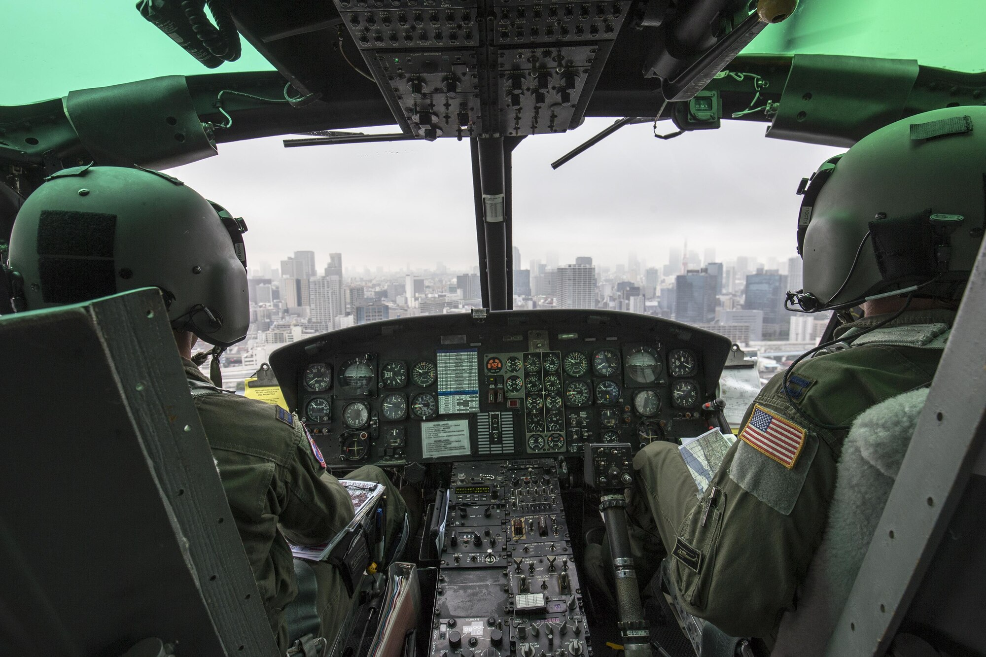 Capt. Jonathan Bonilla and Capt. Vicente Vasquez, 459th Airlift Squadron UH-1N Iroquois pilots, fly over Tokyo metropolis, Sept. 4, 2016. Airmen with the 459 AS delivered simulated disaster relief supplies to the Tokyo Rinkai Disaster Prevention Park during annual Tokyo Metropolitan Government Disaster Management Drill. The park is located in the Ariake area and is a disaster countermeasure headquarters of the Government of Japan and other local governments during large-scale earthquakes in the metropolitan area. (U.S. Air Force photo by Yasuo Osakabe/Released) 
