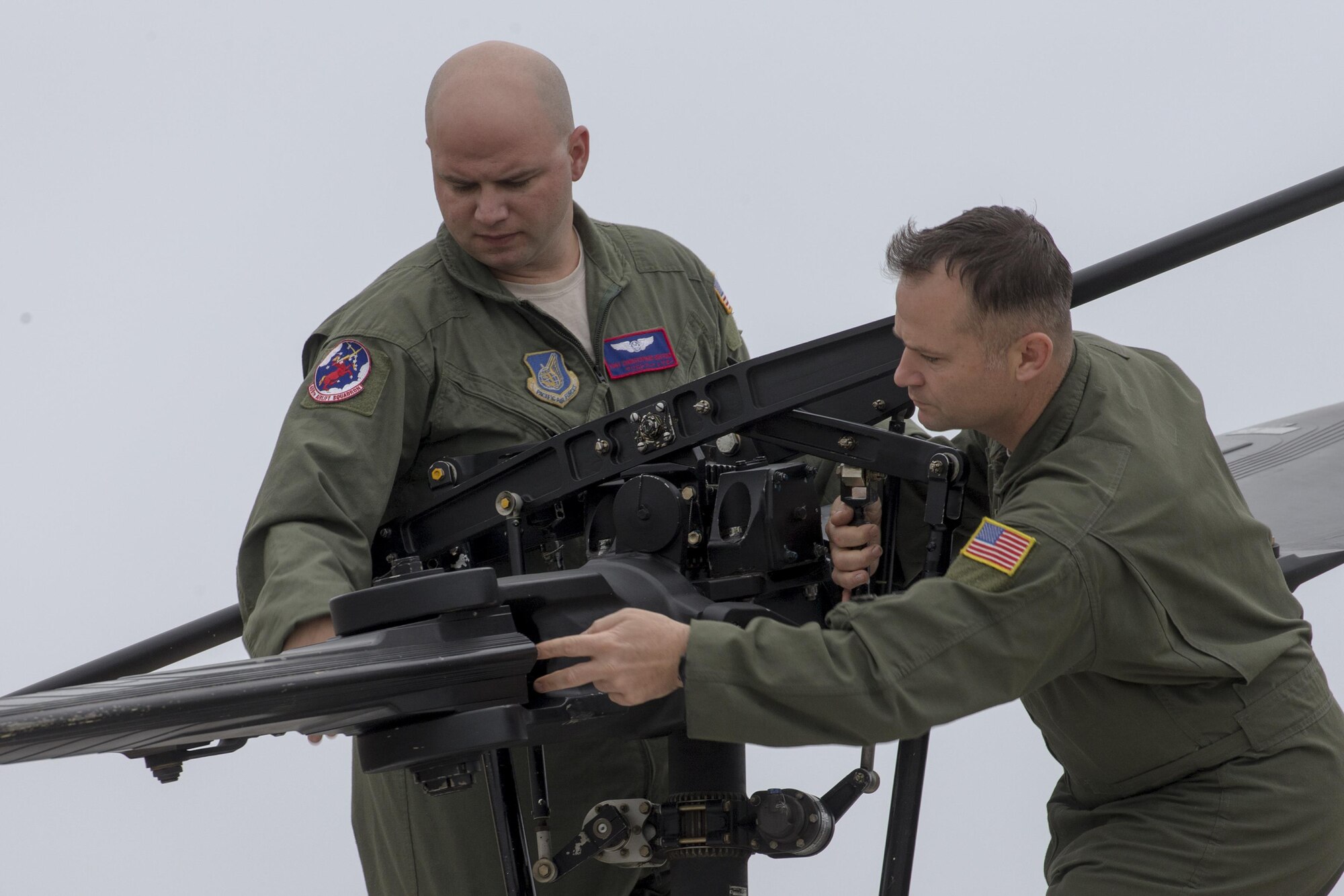 (Right to left) Senior Master Sgt. Edward Sponenburg, 459th Airlift Squadron superintendent, and Tech. Sgt. Christopher Rector, 459 AS flight engineer, perform pre-flight inspection on a UH-1N Iroquois at Yokota Air Base, Japan, Sept. 4, 2016, during the Tokyo Metropolitan Government Disaster Management Drill. Airmen with the 459 AS delivered simulated disaster relief supplies to the Tokyo Rinkai Disaster Prevention Park during the drill. The park is located in the Ariake area and is a disaster countermeasure headquarters of the Government of Japan and other local governments during large-scale earthquakes in the metropolitan area. (U.S. Air Force photo by Yasuo Osakabe/Released) 