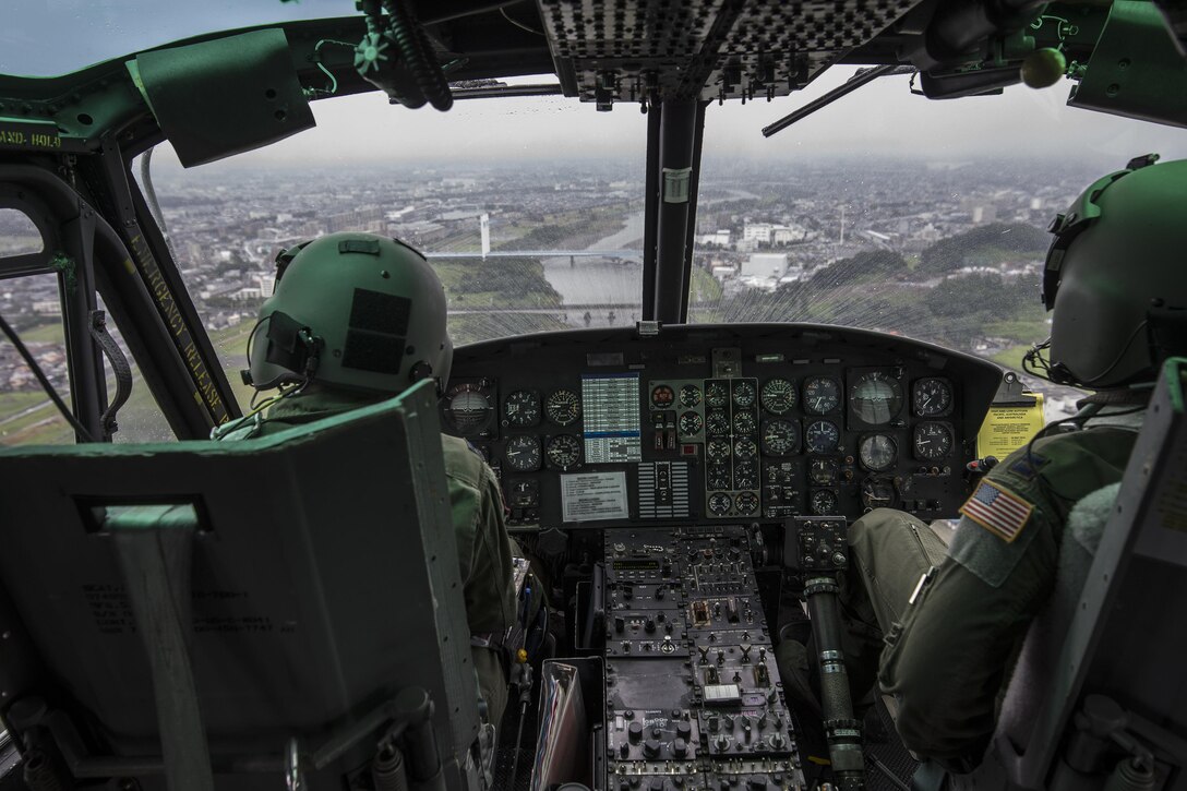 Capt. Jonathan Bonilla and Capt. Vicente Vasquez, 459th Airlift Squadron UH-1N Iroquois pilots, fly over the Tama River in Japan, Sept. 4, 2016. Airmen with the 459 AS delivered simulated disaster relief supplies to the Tokyo Rinkai Disaster Prevention Park during the Annual Tokyo Metropolitan Government Disaster Management Drill. The park is located in the Ariake area and is a disaster countermeasure headquarters of the Government of Japan and other local governments during large-scale earthquakes in the metropolitan area. (U.S. Air Force photo by Yasuo Osakabe/Released) 