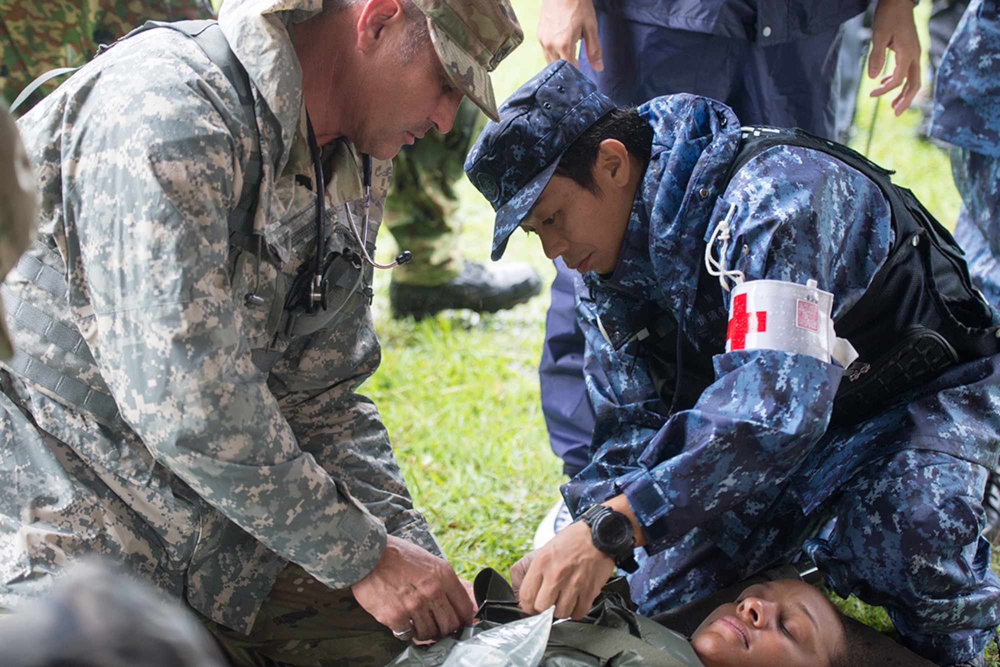 Army Staff Sgt. Steven Rutherford, 94th Combat Support Hospital medic, administers care to a simulated patient during the Kanagawa Prefecture Government Joint Disaster Drill at Japan Air Self-Defense Force Camp Takeyama, Japan, Sept. 11, 2016. Throughout the exercise, U.S. Armed Forces and Japan Self-Defense Force members practiced providing on-sight medical relief to simulated victims of various natural disasters. (U.S. Air Force photo by Senior Airman Delano Scott/Released)