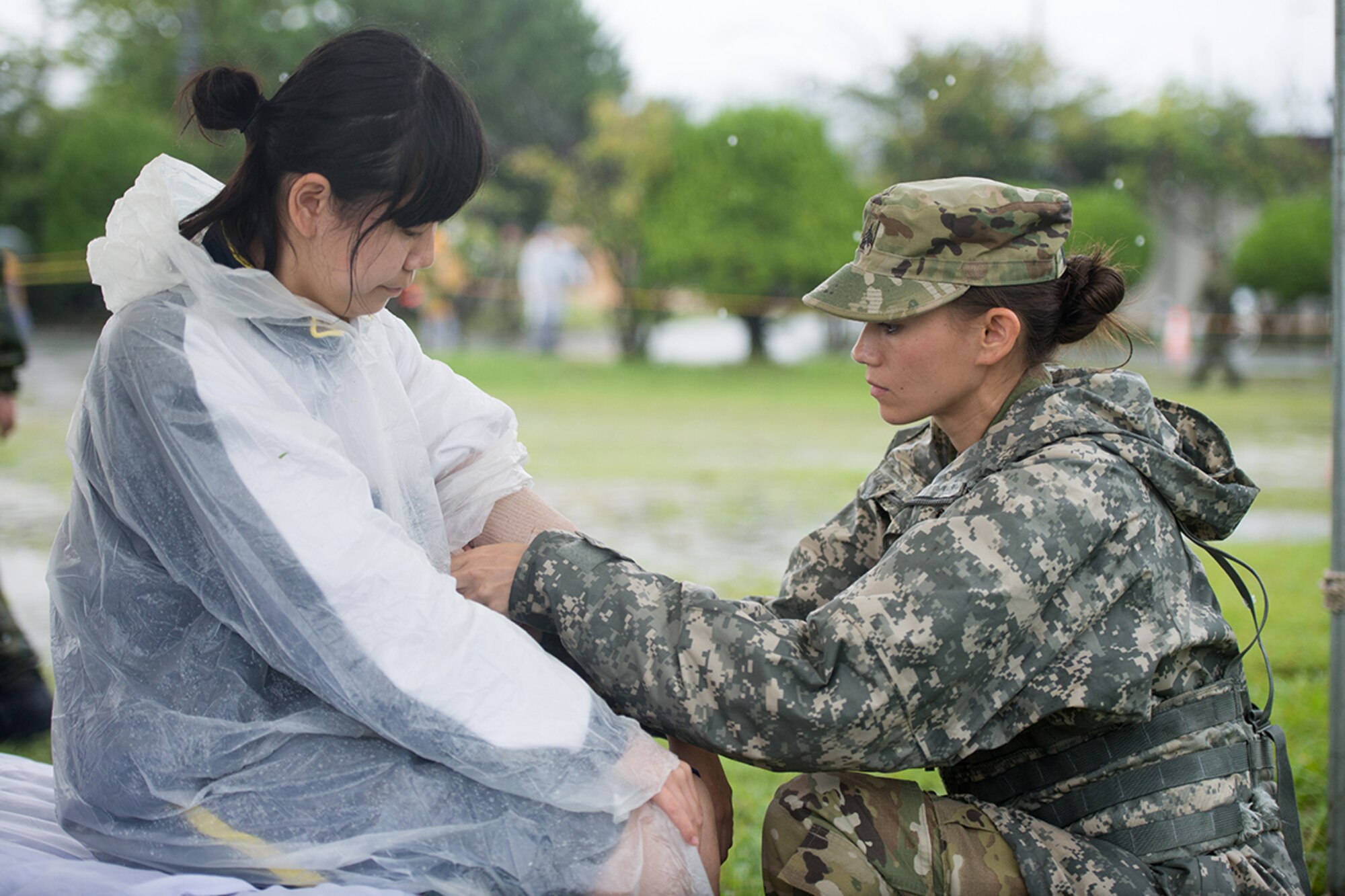 Army Sgt. Marlise Muenzer, 94th Combat Support Hospital medic, administers care to a simulated patient during the Kanagawa Prefecture Government Joint Disaster Drill of at Japan Ground Self-Defense Force Camp Takeyama, Japan, Sept. 11, 2016. The exercise provided an opportunity for U.S. Armed Forces members to strengthen partnerships with Japan Self-Defense Forces. (U.S. Air Force photo by Senior Airman Delano Scott/Released)