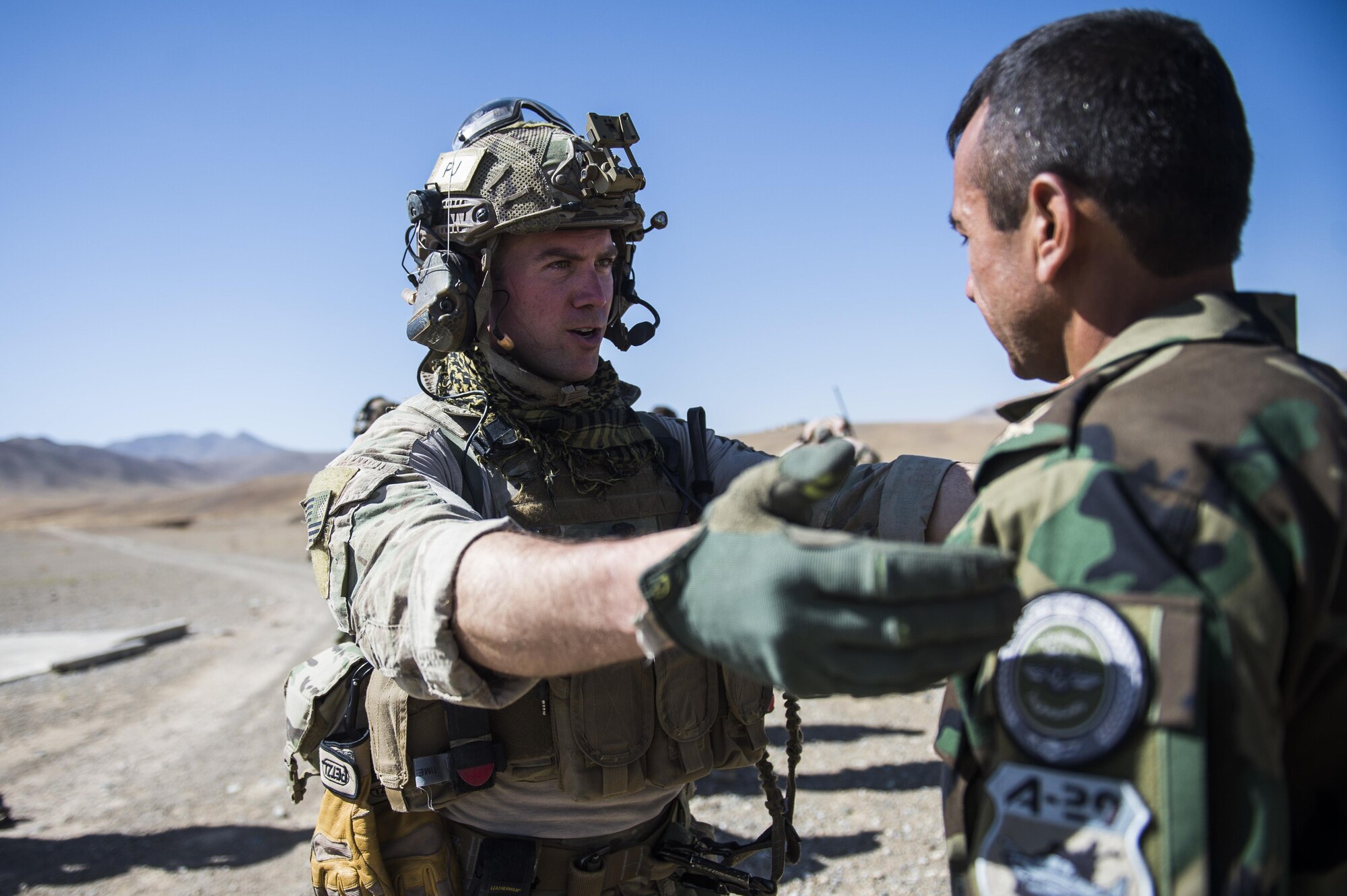 Senior Airman Bradley Menefee, a pararescueman assigned to the 83rd Expeditionary Rescue Squadron, provides brief instruction to an Afghan Air Force pilot  on hoist operations during a training mission near Kabul, Afghanistan, Sept. 6, 2016. Airmen from the 83rd ERQS, provided personnel recovery scenario training to the Afghan Air Force's A-29 pilots.
(U.S. Air Force photo/Tech. Sgt. Larry E. Reid Jr., Released)