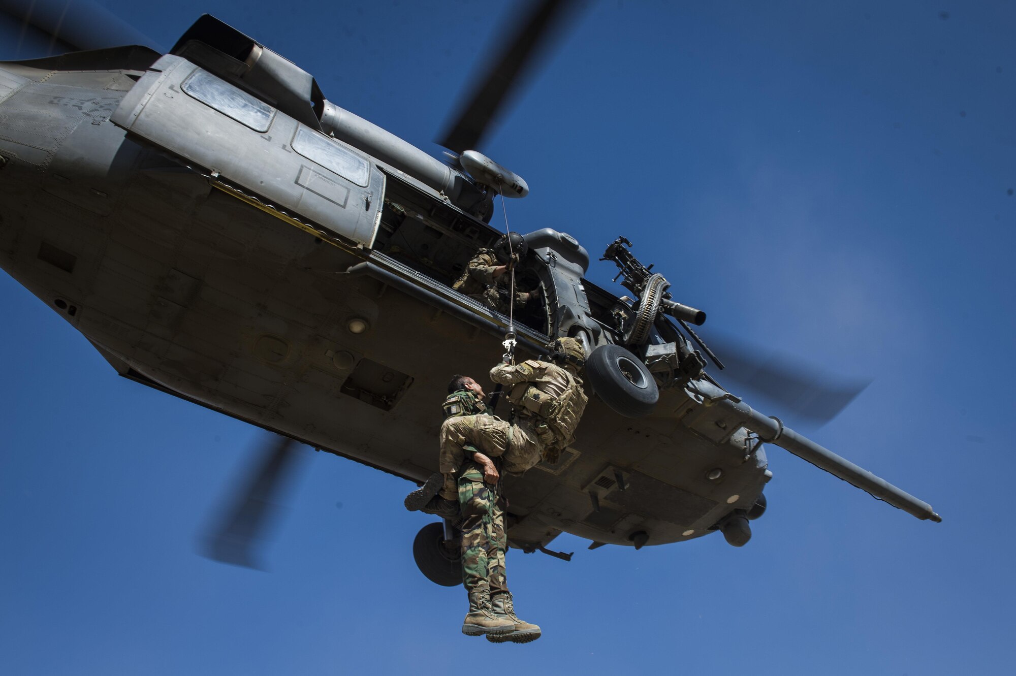 Staff Sgt. Kyle Green, a pararescueman assigned to the 83rd Expeditionary Rescue Squadron, hoist an Afghan Air Force pilot into a HH-60 Pave Hawk during a training mission near Kabul, Afghanistan, Sept. 6, 2016. Airmen from the 83rd ERQS, provided personnel recovery scenario training to the Afghan Air Force's A-29 pilots.
(U.S. Air Force photo/Tech. Sgt. Larry E. Reid Jr., Released)