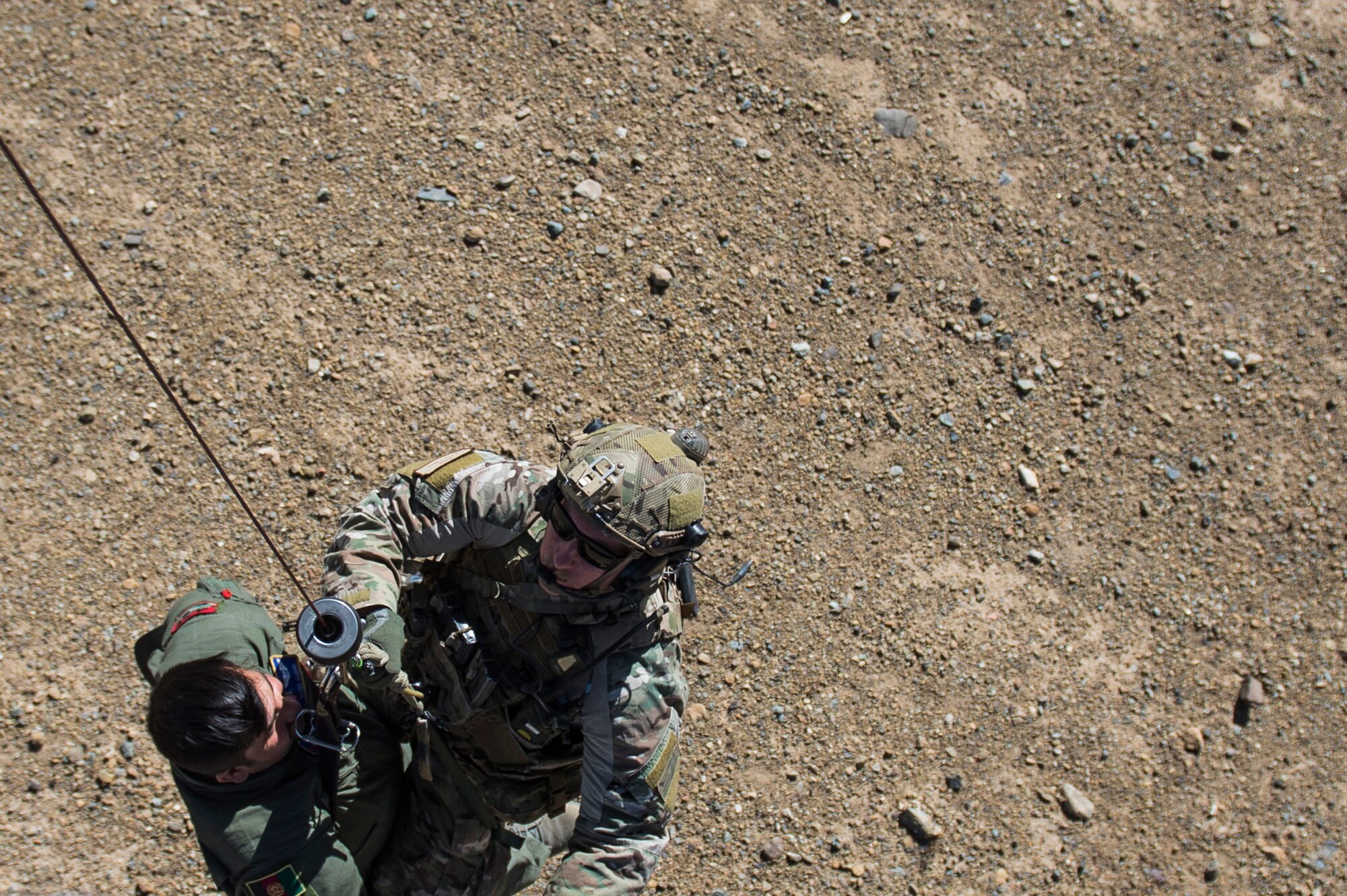 Staff Sgt. Kyle Green, a pararescueman assigned to the 83rd Expeditionary Rescue Squadron, hoist an Afghan Air Force pilot into a HH-60 Pave Hawk during a training mission near Kabul, Afghanistan, Sept. 6, 2016. Airmen from the 83rd ERQS, provided personnel recovery scenario training to the Afghan Air Force's A-29 pilots.
(U.S. Air Force photo/Tech. Sgt. Larry E. Reid Jr., Released)