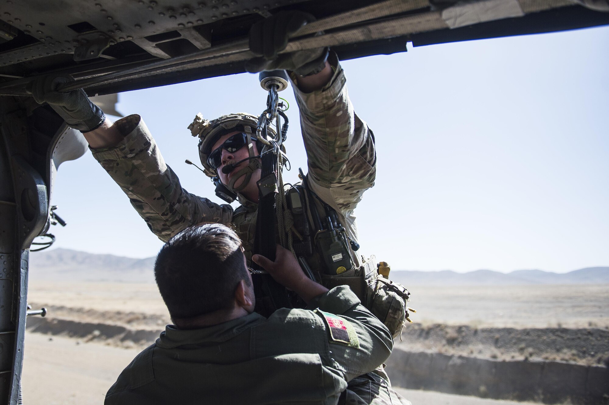 Staff Sgt. Kyle Green, a pararescueman assigned to the 83rd Expeditionary Rescue Squadron, hoist an Afghan Air Force pilot into a HH-60 Pave Hawk during a training mission near Kabul, Afghanistan, Sept. 6, 2016. Airmen from the 83rd ERQS, provided personnel recovery scenario training to the Afghan Air Force's A-29 pilots.
(U.S. Air Force photo/Tech. Sgt. Larry E. Reid Jr., Released)