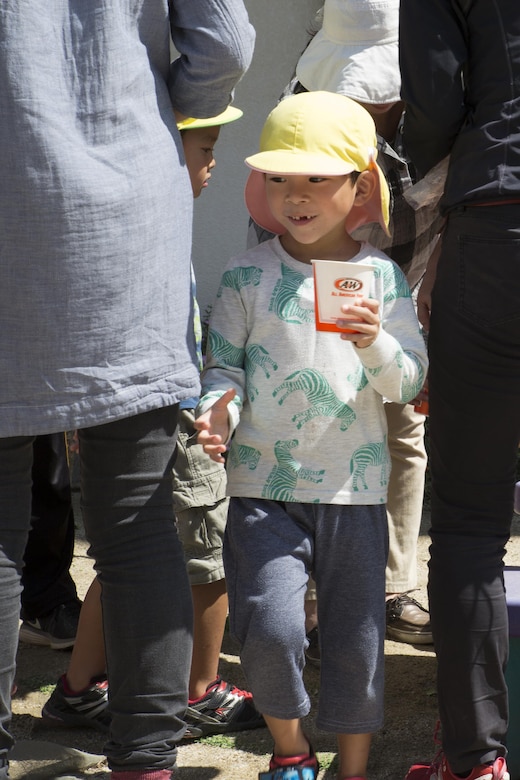 A local Japanese child smiles after receiving juice at Ekimae Hoikuen preschool in Iwakuni, Japan, Sept. 8, 2016. Seabees with the Marine Memorial Chapel at Marine Corps Air Station Iwakuni passed out drinks and chips to the children. (U.S. Marine Corps photo by Lance Cpl. Joseph Abrego)