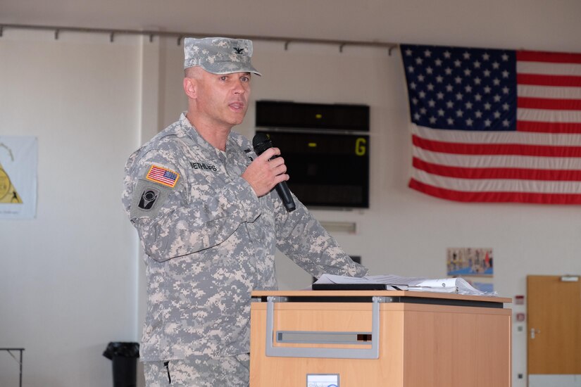 Col. John E. Dethlefs speaks after taking command of the 7th Mission Support Command’s 209th Digital Liaison Detachment during a change of command ceremony at McCully Barracks Fitness Center, Sept. 10, 2016.  