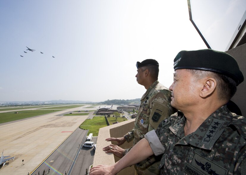 U.S. Army Gen. Vincent K. Brooks, U.S. Forces Korea commander, and Republic of Korea army Gen. Lee, Sun Jin, Chairman of the Republic of Korea Joint Chiefs of Staff, observe a U.S. Air Force B-1B Lancer escorted by ROK F-15K Slam Eagles performing a flyover over Osan Air Base, Republic of Korea, Sept. 13, 2016. Two U.S. Air Force B-1B Lancers from Andersen Air Force Base, Guam, were joined by Republic of Korean F-15K Slam Eagles and U.S. Air Force F-16 Fighting Falcons during the flyover. The close military cooperation between the U.S. and ROK keeps us ready to respond at any time to those who would threaten stability and security. (U.S. Air Force photo by Senior Airman Victor J. Caputo)