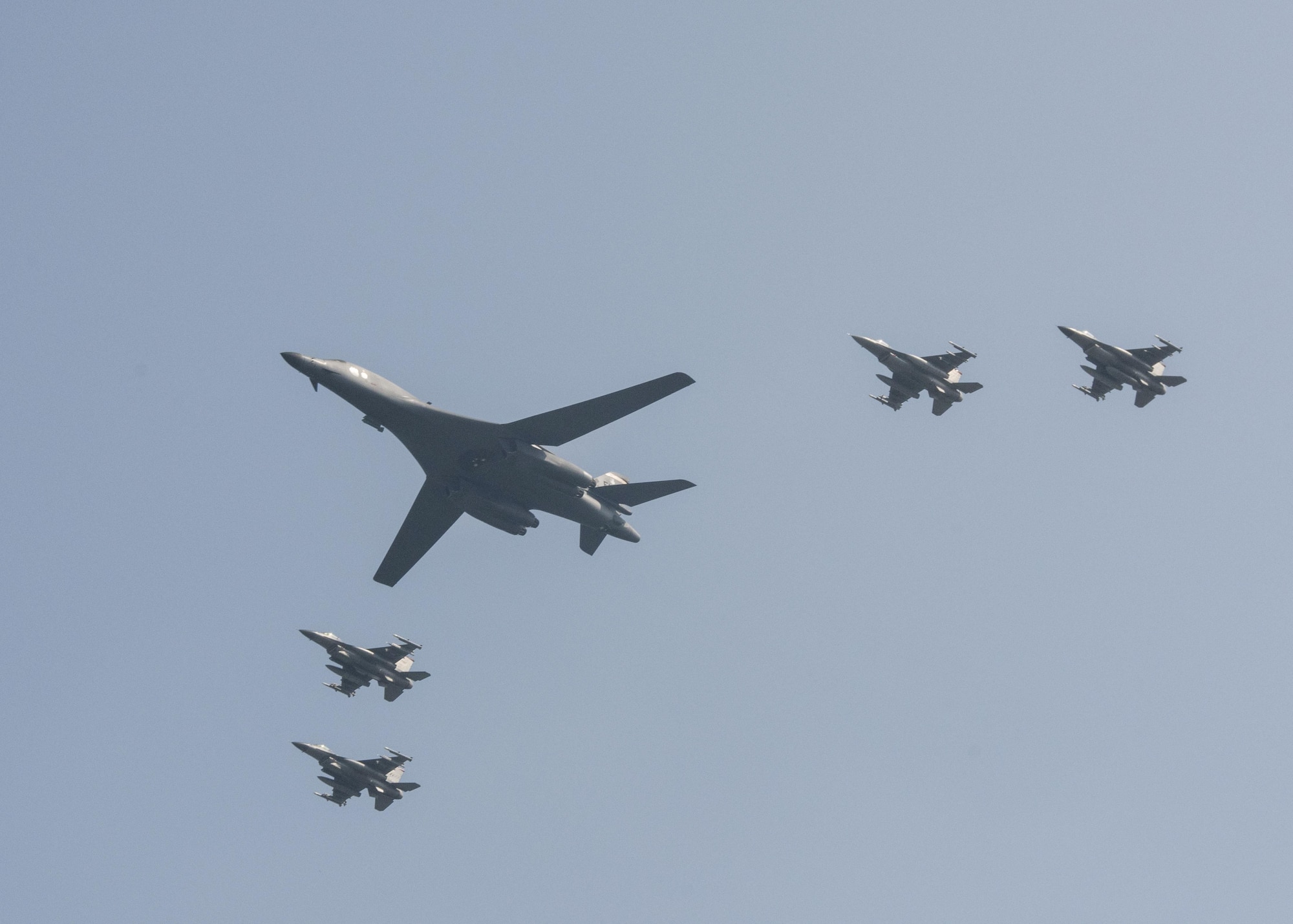 U.S. Air Force F-16 Fighting Falcons assigned to the 36th Fighter Squadron escort a U.S. Air Force B-1B Lancer from Andersen Air Force Base, Guam, during a flyover over Osan Air Base, Republic of Korea, Sept. 13, 2016. The B-1 is capable of rapidly delivering massive quantities of precision and non-precision weapons against any adversary, anywhere in the world, at any time. (U.S. Air Force photo by Victor J. Caputo)