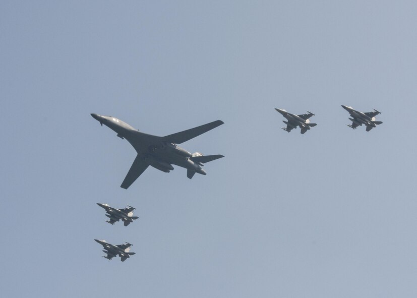 U.S. Air Force F-16 Fighting Falcons assigned to the 36th Fighter Squadron escort a U.S. Air Force B-1B Lancer from Andersen Air Force Base, Guam, during a flyover over Osan Air Base, Republic of Korea, Sept. 13, 2016. The B-1 is capable of rapidly delivering massive quantities of precision and non-precision weapons against any adversary, anywhere in the world, at any time. (U.S. Air Force photo by Victor J. Caputo)
