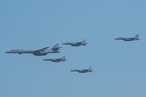A U.S. Air Force B-1B Lancer, escorted by Republic of Korea air force F-15K Slam Eagles, performs a flyover over Osan Air Base, ROK, Sept. 13, 2016. The flyover highlighted the close cooperation between American and ROK military forces that keeps them ready to respond at any time to threats to stability and security. The B-1s are currently assigned to Andersen Air Force Base, Guam. (U.S. Air Force photo by Senior Airman Dillian Bamman)