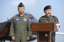 Republic of Korea air force Lt. Gen. Lee Wang Keun, Republic of Korea Air Forces Operations Center commander, stands by listening to Republic of Korea army Gen. Lee, Sun Jin, Chairman of the Republic of Korea Joint Chiefs of Staff, speak during a press conference following a flyover in response to recent provocative action by North Korea, Sept. 13. 2016, at Osan air Base, ROK. Two U.S. Air Force B-1 Lancers from Andersen Air Force Base, Guam, were joined by Republic of Korean F-15K Slam Eagles and U.S. Air Force F-16 Fighting Falcons during the flyover. The close military cooperation between the U.S. and ROK keeps us ready to respond at any time to those who would threaten stability and security. (U.S. Air Force photo by Tech. Sgt. Rasheen Douglas)