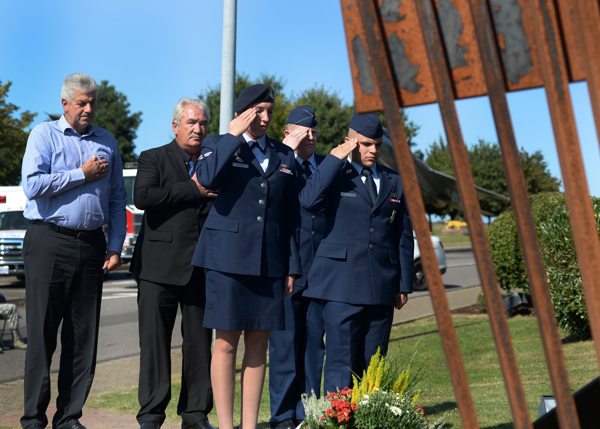 Local German community leaders and Airmen from the 52nd Fighter Wing pause to reflect during the 9/11 memorial service at Spangdahlem Air Base, Germany, Sept. 9, 2016. Local German and Air Force leadership spoke about the effects of attacks on the U.S. created a stronger alliance with German and NATO partners. (U.S. Air Force photo/Senior Airman Dawn M. Weber)