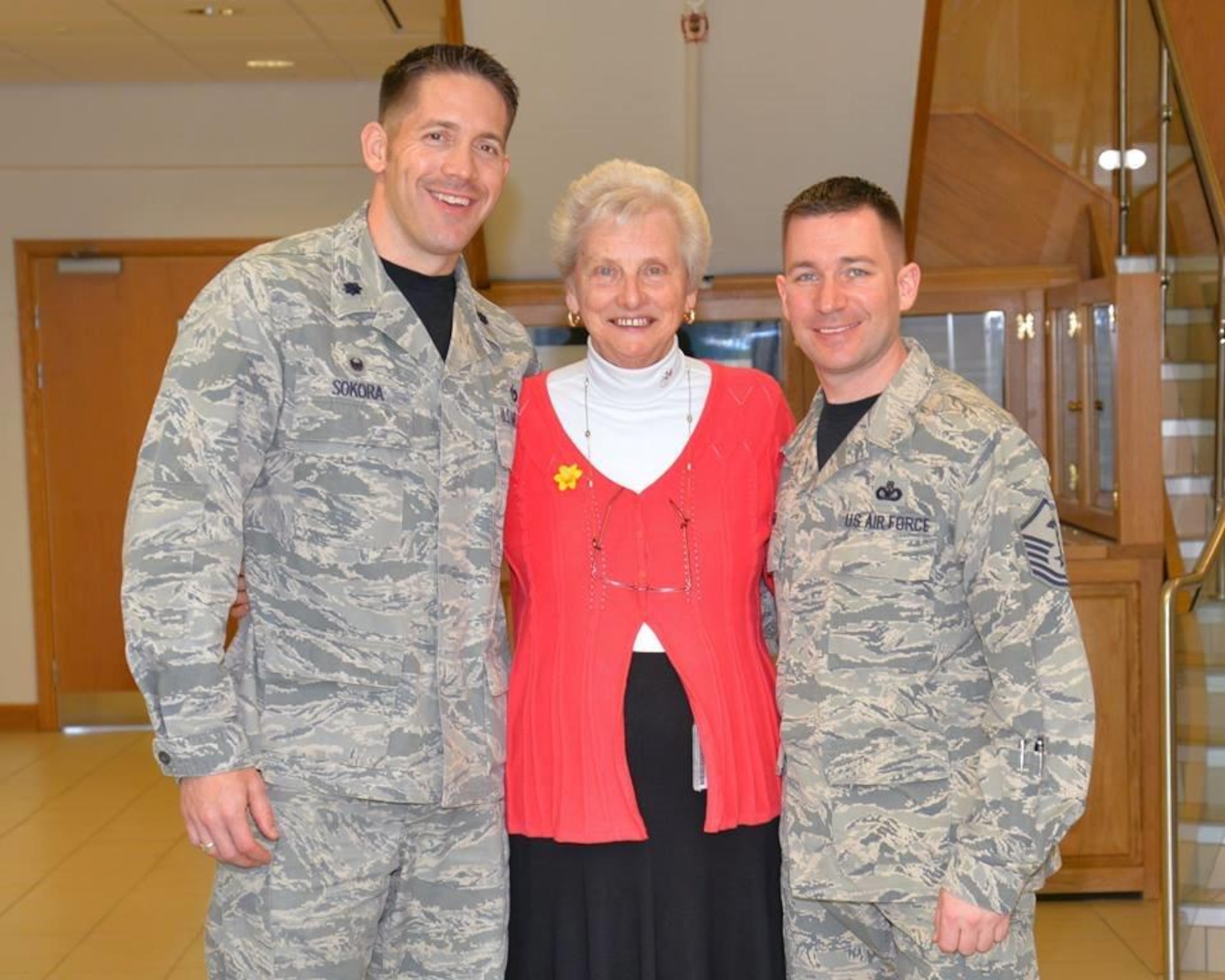 Faith Rutterford, center, 100th Civil Engineer Squadron secretary, poses for a photograph with U.S. Air Force Lt. Col. Brandon Sokora, 100th CES commander, left, and U.S. Air Force Master Sgt. Cody Green, 100th CES first sergeant, March 2016, on RAF Mildenhall, England. Over her 57 years of service Rutterford has worked for 27 commanders. (U.S. Air Force photo by Karen Abeyasekere)