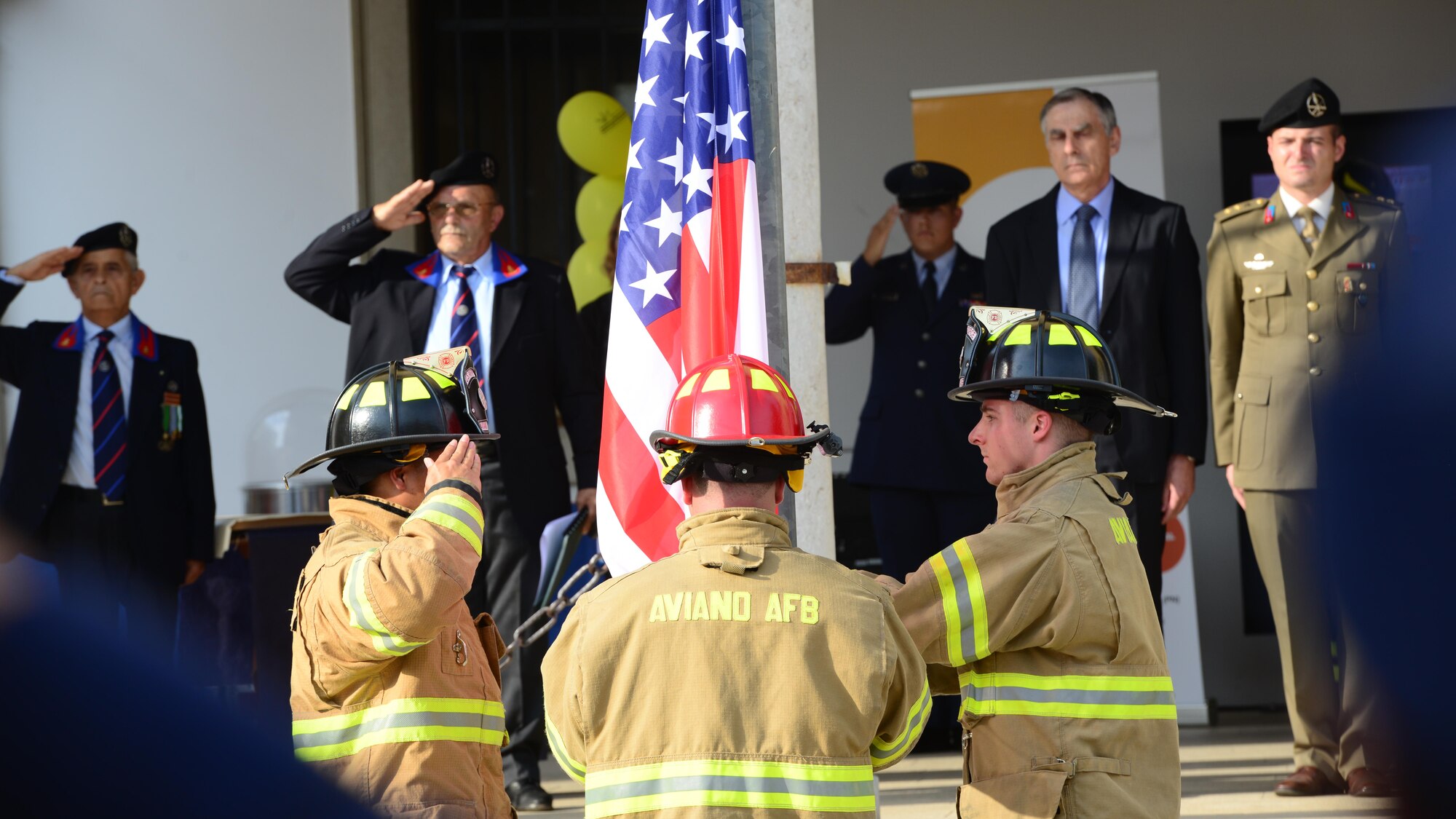Firefighters from the 31st Civil Engineer Squadron raise the U.S. flag during a 9/11 memorial ceremony in Spilimbergo, Italy on Sept. 10, 2016. The ceremony was part of the 15th Annual Italian-American Friendship Festival. (U.S. Air Force photo by Tech. Sgt. R.J. Biermann/Released) 