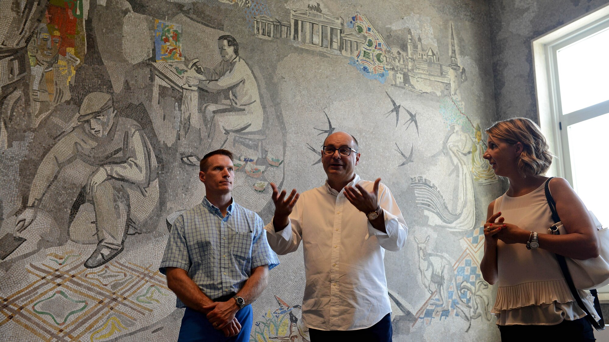 Giampiero Brovedani, Mosaic School of Friuli director (center), speaks as Brig. Gen. Lance Landrum, 31st Fighter Wing commander (left), and Angela Zammattio, 31st FW Public Affairs specialist (right), listen during a school tour in Spilimbergo, Italy on Sept. 10, 2016. The tour was one of several events hosted by the city to bring Italians and Americans together during the 15th Annual Italian-American Friendship Festival. (U.S. Air Force photo by Tech. Sgt. R.J. Biermann/Released)