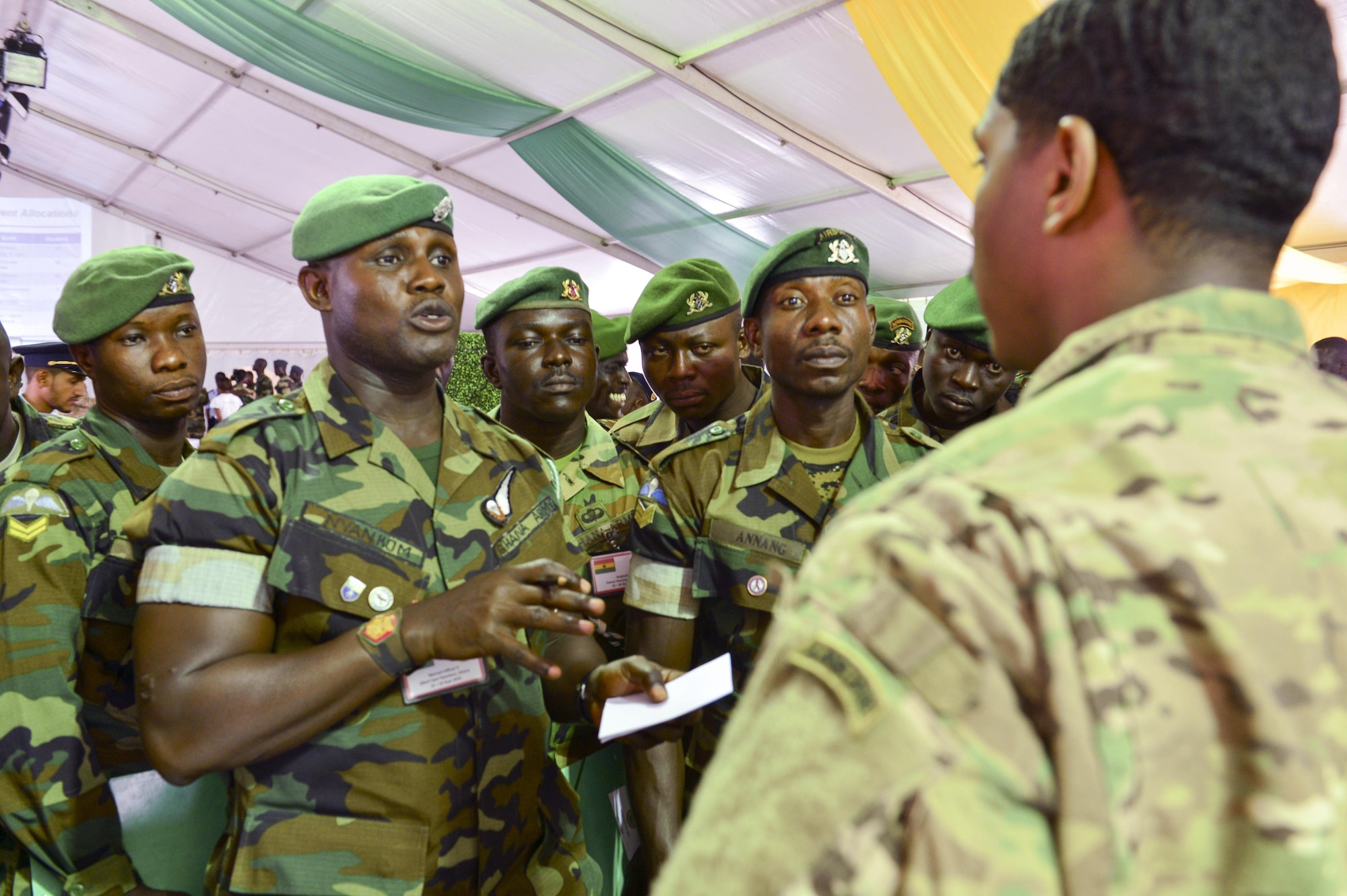 Staff Sgt. Robby Royster, right, 435th Security Forces Squadron jumpmaster meets with Ghanaian army airborne students to discuss training objectives during African Partnership Flight in Accra Air Base, Ghana Sept. 12, 2016. The Ghanaian army will be parachuting off an C-130J Super Hercules during APF, this is will help them maintain certification and remain current on personnel drops. (U.S. Air Force photo by Staff Sgt. Stephanie Longoria)