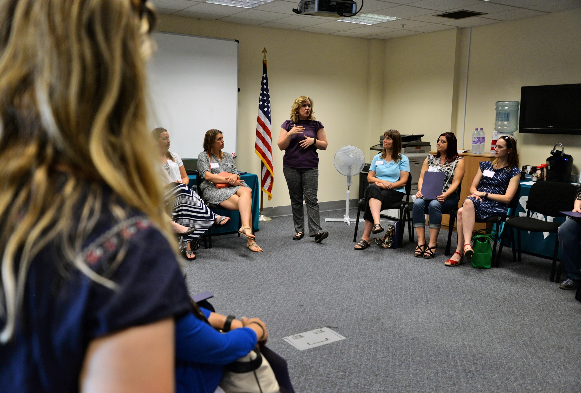 Genevieve Brock, 100th Air Refueling Wing Sexual Assault Prevention and Response victim advocate, briefs Team Mildenhall spouses Sept. 8, 2016, on RAF Mildenhall, England. The Spouse Immersion Tour gave Team Mildenhall spouses an opportunity to network and gain a better understanding of programs and facilities on base. (U.S. Air Force photo by Senior Airman Christine Halan)