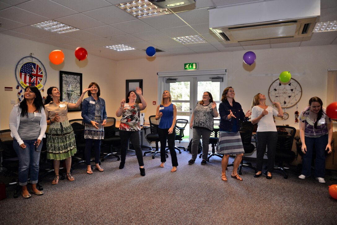 Spouses of U.S. Air Force members play a game as part of a resiliency initiative briefing during the Spouse Immersion Tour, Sept. 8, 2016, on RAF Mildenhall, England. The tour gave Team Mildenhall spouses an opportunity to network and gain a better understanding of programs and facilities on base. (U.S. Air Force photo by Senior Airman Christine Halan)