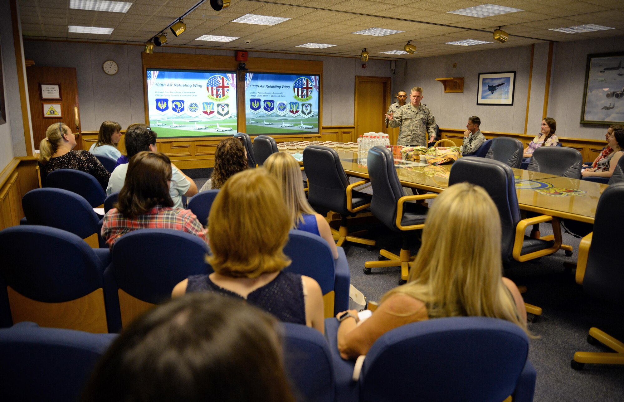 U.S. Air Force Col. Thomas D. Torkelson, 100th Air Refueling Wing commander, briefs the wing’s mission to Team Mildenhall spouses Sept. 8, 2016, on RAF Mildenhall, England. The Spouse Immersion Tour gave Team Mildenhall spouses an opportunity to network and gain a better understanding of programs and facilities on base. (U.S. Air Force photo by Senior Airman Christine Halan)