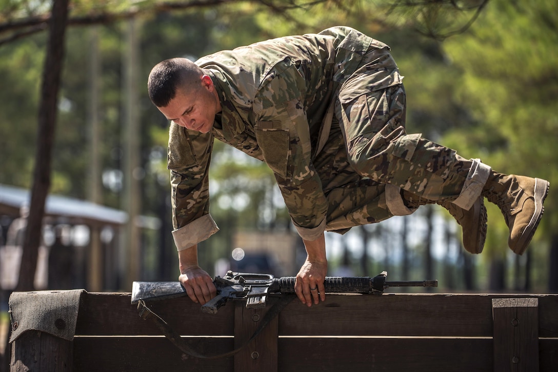 Army Sgt. 1st Class Jason Scott hurdles the low wall on the obstacle course during the Army Reserve Drill Sergeant of the Year competition at Fort Jackson, S.C., Sept. 8, 2016. Scott is assigned to the 95th Training Division. Army photo by Sgt. 1st Class Brian Hamilton
