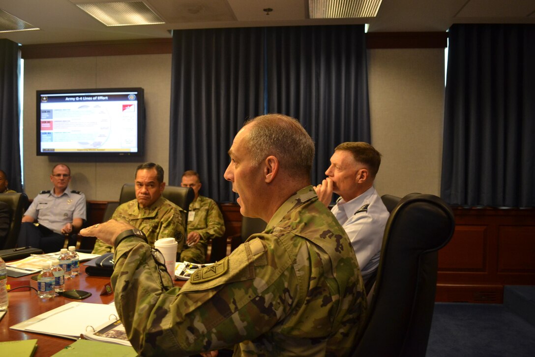 Army Lt. Gen. Gustave Perna (foreground) speaks at Army/DLA Day, Sept. 8 at the Pentagon, as (from far left) Air Force Brig. Gen. Martin Chapin, commander of DLA Energy, Army Command Sgt. Maj. Charles Tobin and Air Force Lt. Gen. Andy Busch listen.