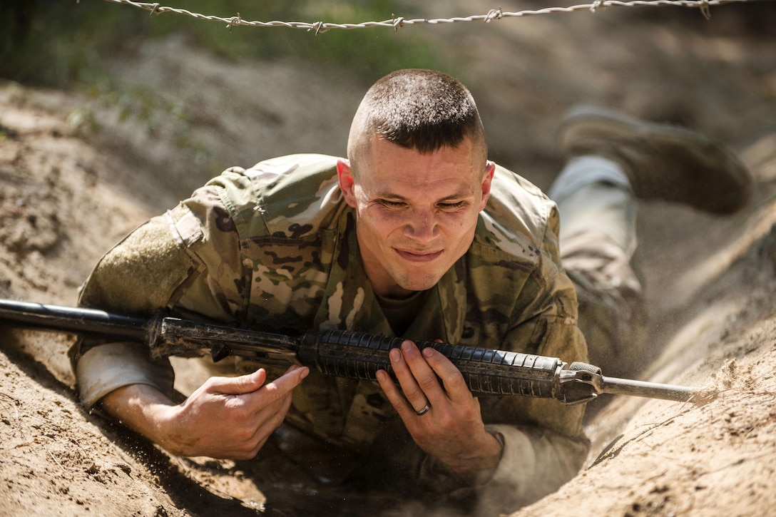Army Sgt. 1st Class Jason Scott crawls under a barbed wire obstacle during the Army Reserve Drill Sergeant of the Year competition at Fort Jackson, S.C., Sept. 8, 2016. Scott is assigned to the 95th Training Division. Army photo by Sgt. 1st Class Brian Hamilton