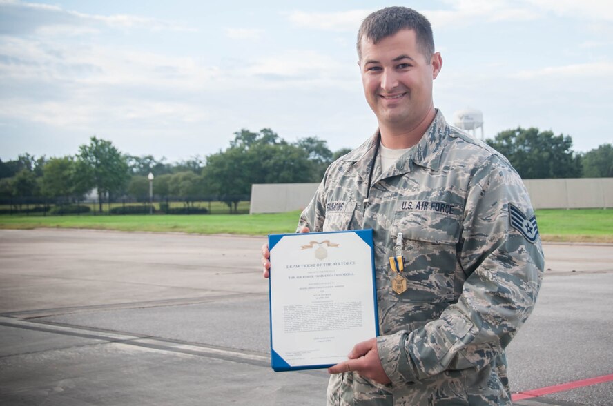 Staff Sgt. Christopher Simmons, 403rd Maintenance Squadron maintainer, holds an Air Force Commendation medal that was presented to him Sept. 11 at Keesler Air Force Base, Mississippi. Simmons received the medal for helping evacuate more than 600 inmates and guards from Escambia County Jail after an explosion and also preventing a secondary explosion there in 2014.(U.S. Air Force photo/Senior Airman Heather Heiney) 