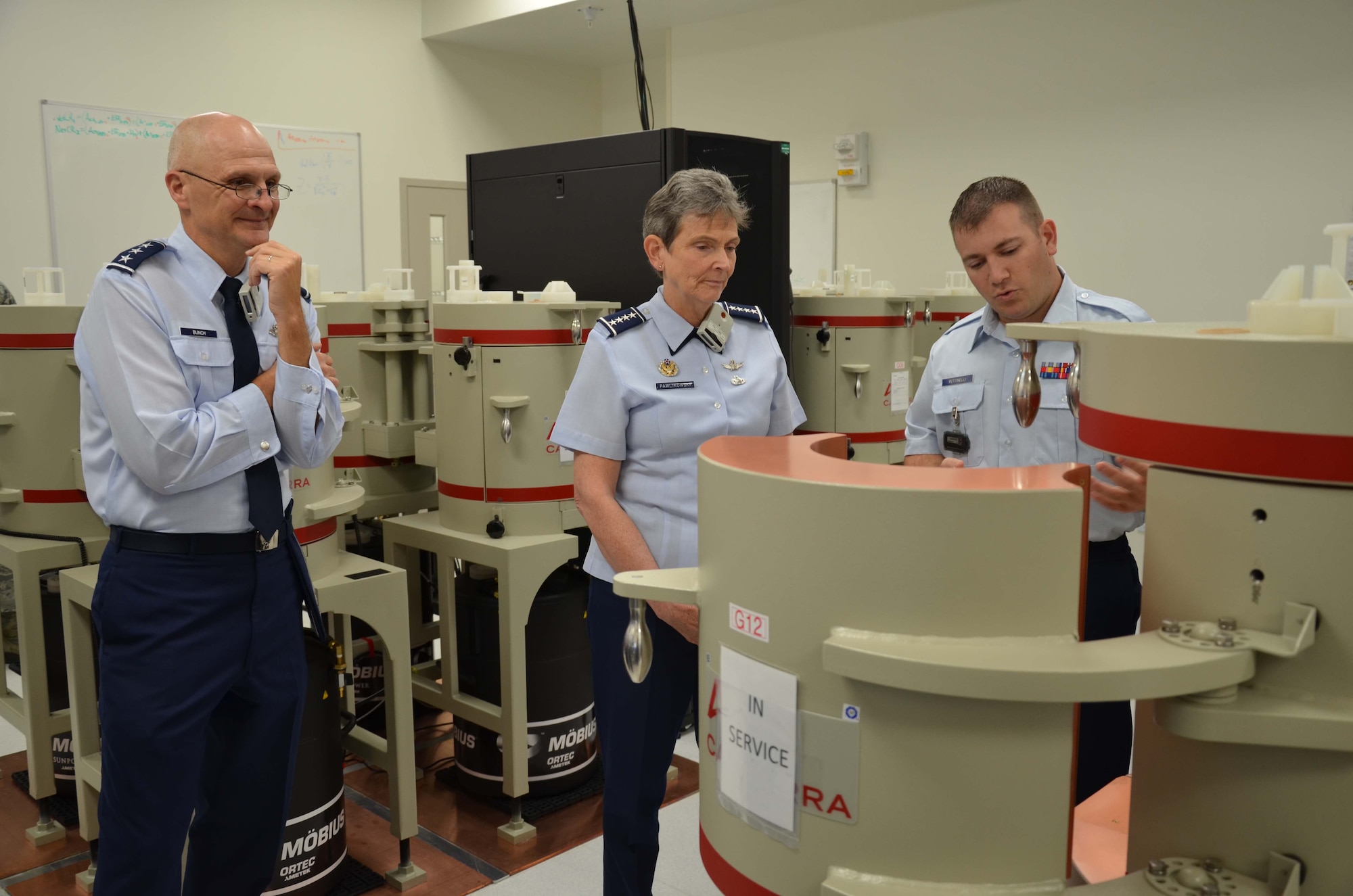 Gen. Ellen M. Pawlikowski, commander of Air Force
Materiel Command, and Lt. Gen. Arnold Bunch, military deputy in the Assistant Secretary for the Office of the Assistant Secretary of the Air Force for Acquisition, listen to Staff Sgt. David A. Pettinelli Jr., a radiochemistry lab technician at the Air Force Technical Applications Center, brief them about the capabilities of equipment in AFTAC's Ciambrone Radiochemistry Lab.  The generals were in town to participate in the 2016 Women in Science and Engineering Symposium at Patrick AFB, Fla., Sept. 7, 2016.  (U.S. Air Force photo by Scott Powell)
