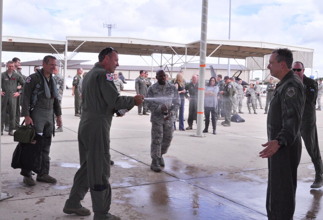 Col. John M. Breazeale gets sprayed by members of the 457th Fighter Squadron and 301st Fighter Wing after his final flight as wing commander Sept. 10 at Naval Air Station Fort Worth Joint Reserve Base, Texas. Breazeale served as the commander from October 2013 to September 2016. He is a command pilot with more than 4,000 flying hours. (U.S. Air Force photo by Staff Sgt. Melissa Harvey)