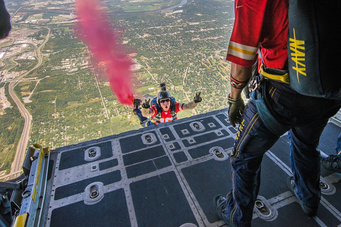 Members of the U.S. Navy Parachute Demonstration Team, the Leap Frogs, jump out of a C-130 Hercules aircraft into Arrowhead Stadium for the Kansas City Chiefs versus San Diego Chargers salute to service members football game in Kansas City, Missouri, Sept. 11, 2016. Air National Guard photo by Senior Airman Sheldon Thompson
