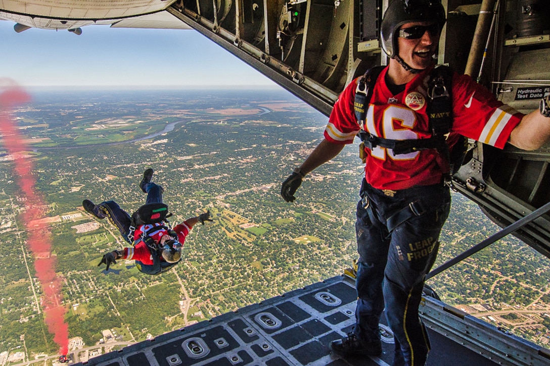 A member of the Navy's parachute demonstration team, the Leap Frogs, is upside-down after jumping out of an Air Force C-130 Hercules aircraft over Arrowhead Stadium during the Kansas City Chiefs vs. San Diego Chargers salute to service members football game in Kansas City, Mo., Sept. 11, 2016. Air National Guard photo by Senior Airman Sheldon Thompson