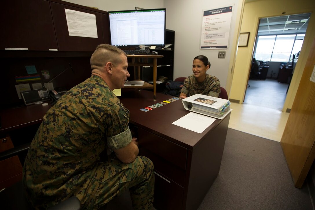 Staff Sgt Craig W. Harriman, left, speaks to Cpl. Andrea N. Villacis about her career progression aboard Marine Corps Air Station Cherry Point, N.C., Sept. 12, 2016. Harriman was awarded Career Planner of the Year for fiscal year 2016 and has been recently selected to instruct at the Basic Career Planners Course at Marine Corps Recruit Depot, San Diego, Calif. He attributes his success to the leadership and mentoring he received during his years in the Corps. Harriman is the staff noncommissioned officer in charge of career planners assigned to Marine Air Control Group 28, 2nd Marine Aircraft Wing. Villacis is an administrative clerk with the unit. (U.S. Marine Corps photo by Sgt. N.W. Huertas/ Released)