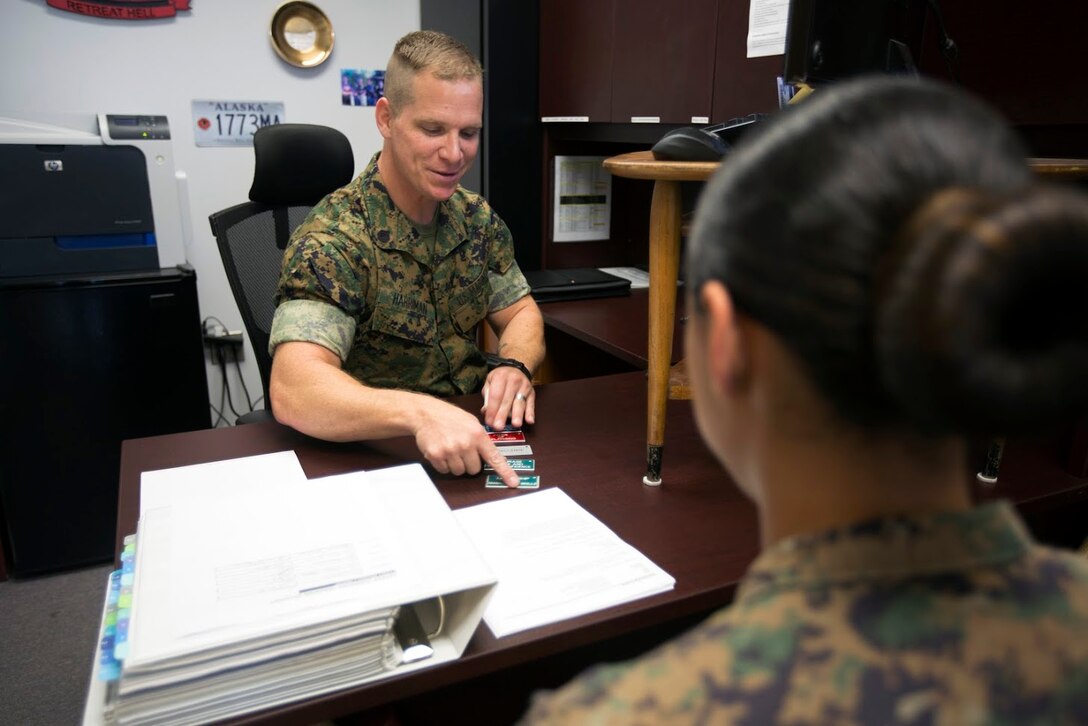 Staff Sgt Craig W. Harriman, left, speaks to Cpl. Andrea N. Villacis about her career progression aboard Marine Corps Air Station Cherry Point, N.C., Sept. 12, 2016. Harriman was awarded Career Planner of the Year for fiscal year 2016 and has been recently selected to instruct at the Basic Career Planners Course at Marine Corps Recruit Depot, San Diego, Calif. He attributes his success to the leadership and mentoring he received during his years in the Corps. Harriman is the staff noncommissioned officer in charge of career planners assigned to Marine Air Control Group 28, 2nd Marine Aircraft Wing. Villacis is an administrative clerk with the unit. (U.S. Marine Corps photo by Sgt. N.W. Huertas/ Released)