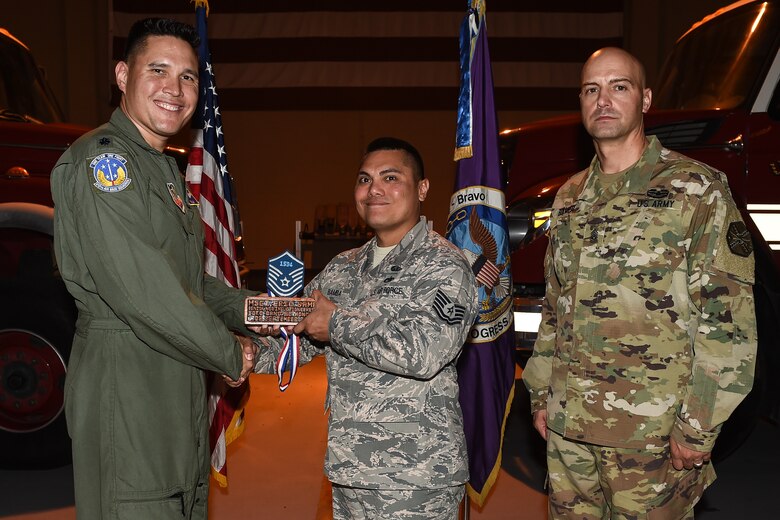 U.S. Air Force Tech. Sgt. Eric Anthony C. Bamba (center), Army Support Activity housing NCO in charge, poses for a photo with Lt. Col. David Aragon, 612th Air Base Squadron commander, and U.S. Army Cmd. Sgt. Maj. Robin Bolmer, ASA command sergeant major, during the first senior non-commissioned officer induction ceremony held at Soto Cano Air Base, Honduras, Sept. 9, 2016. Bamba was raised in Guam, and entered the Air Force in 2000.
