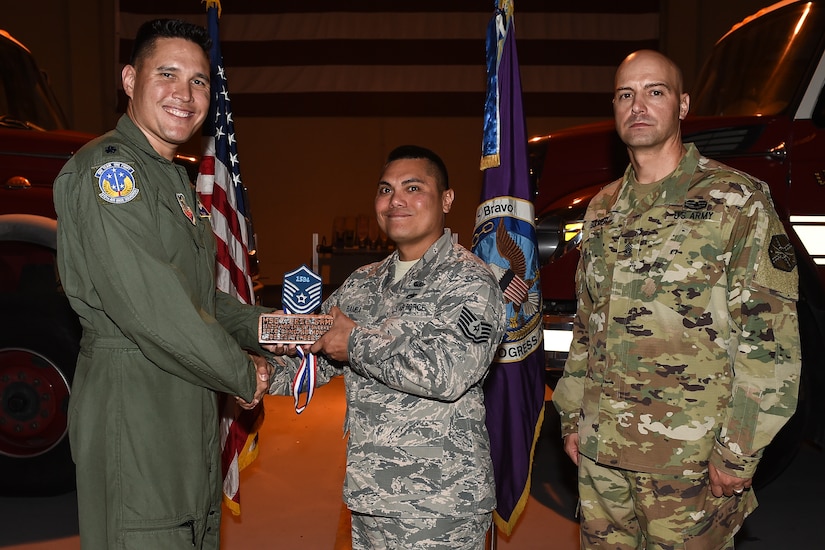 U.S. Air Force Tech. Sgt. Eric Anthony C. Bamba (center), Army Support Activity housing NCO in charge, poses for a photo with Lt. Col. David Aragon, 612th Air Base Squadron commander, and U.S. Army Cmd. Sgt. Maj. Robin Bolmer, ASA command sergeant major, during the first senior non-commissioned officer induction ceremony held at Soto Cano Air Base, Honduras, Sept. 9, 2016. Bamba was raised in Guam, and entered the Air Force in 2000.