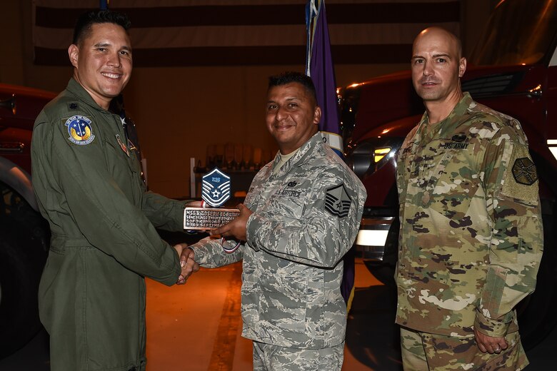 U.S. Air Force Master Sgt. Joseph A. Flores (center), 612th Air Base Squadron assistant fire chief of fire operations, poses for a photo with Lt. Col. David Aragon, 612th ABS commander, and U.S. Army Cmd. Sgt. Maj. Robin Bolmer, Army Support Activity command sergeant major, during the first senior non-commissioned officer induction ceremony held at Soto Cano Air Base, Honduras, Sept. 9, 2016. Flores was raised in San Antonio, Texas, and entered the Air Force in 1998.