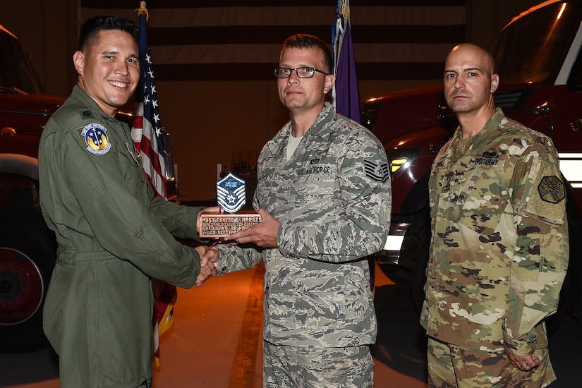 U.S. Air Force Tech. Sgt. Daniel L. Harris (center), 612th Air Base Squadron engineering superintendent of the planning section, poses for a photo with Lt. Col. David Aragon, 612th ABS commander, and U.S. Army Cmd. Sgt. Maj. Robin Bolmer, Army Support Activity command sergeant major, during the first senior non-commissioned officer induction ceremony held at Soto Cano Air Base, Honduras, Sept. 9, 2016. Harris was raised in Newport News, Va., and joined the Air Force in 2004.
